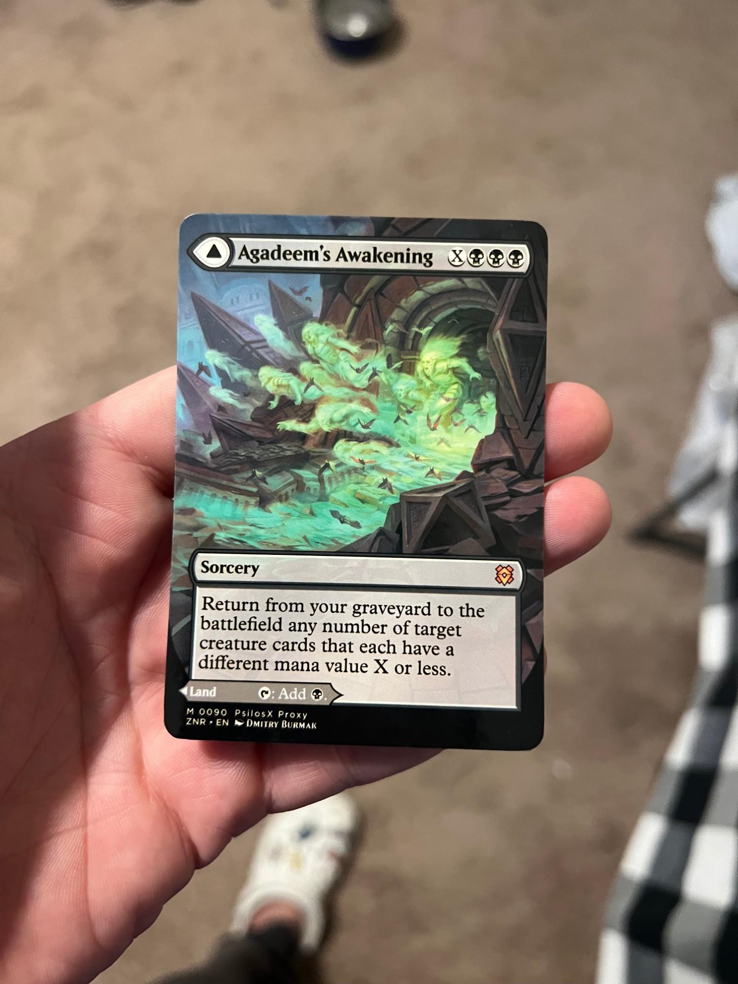 Agadeem's Awakening, borderless foil, in hand.